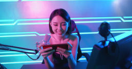 Girl gamer playing mobile game on stream